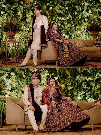 A classic stage portrait of the bride and groom on their wedding day. The lush green backdrop and their regal outfits create a picture-perfect memory.