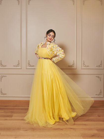 The 'Jauna' outfit in motion. The flowing yellow skirt and structured jacket create a beautiful contrast, making it a standout piece for your haldi ceremony.