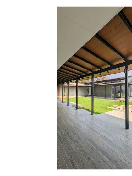 The long, covered walkway of Villa 15. These deep verandahs are crucial for providing shade and creating comfortable outdoor living areas in the tropical climate.