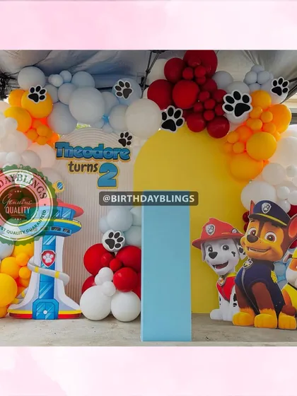 A PAW Patrol party on the go! This setup features Chase, Marshall, and Rubble, with a lookout tower prop and a balloon arch decorated with paw prints.