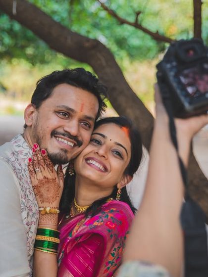 A behind-the-scenes shot of us capturing a happy couple. This shows our process and the genuine connection we build with the people we photograph.