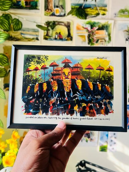 Here is the 'Thrissur Pooram' print in a classic black frame, held against the backdrop of my studio wall. It shows how the artwork can be a beautiful addition to a gallery wall.