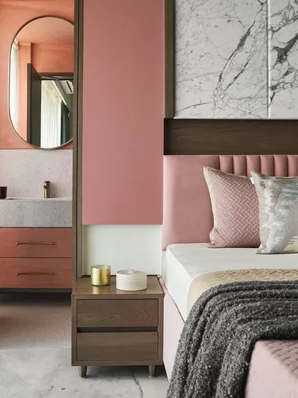 This master bedroom in the Whimsical House was designed as a youthful yet serene retreat. I combined soft pastel pinks and greens with the texture of dyed ash grey wood and the elegance of Satvario marble to create a harmonious and cozy personal space.