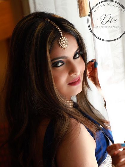 A playful and confident shot of the blue smoky eye look. The highlights in her hair and the intense eye makeup work together to create a very stylish and modern vibe.