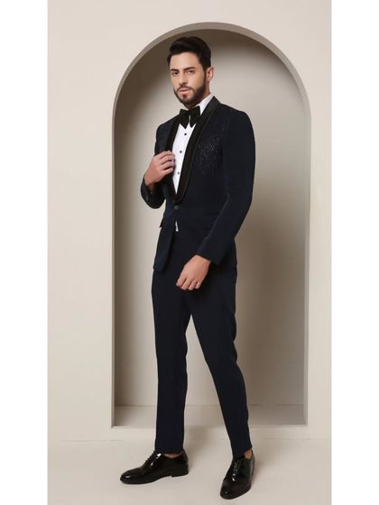 Teal never looked so sharp. This image highlights the classic satin collar of the Prism Riviera tuxedo, which provides a smooth contrast to the captivating geometric glass bead design on the upper chest.