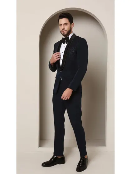 Teal never looked so sharp. This image highlights the classic satin collar of the Prism Riviera tuxedo, which provides a smooth contrast to the captivating geometric glass bead design on the upper chest.