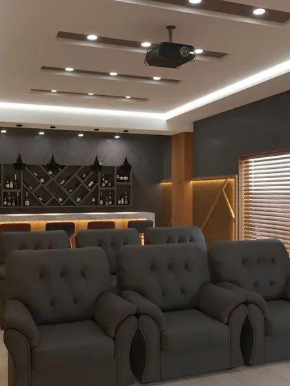 This home theater design includes a dedicated bar at the back of the room. It's the perfect setup for entertaining, combining cinematic viewing with the convenience of a personal concession stand.