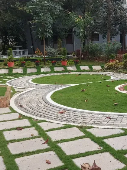 Intricate paving patterns create circular motifs in this public park's lawn. This demonstrates my ability to execute complex hardscape designs.