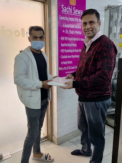 Here I am with a volunteer, distributing warm innerwear. It's a practical way to provide comfort and dignity to those who need it most during the harsh winter season.