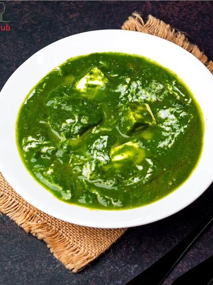 Our Palak Paneer is a crowd favorite. We use fresh spinach to create a vibrant, nutrient-rich gravy and add soft cubes of paneer for a protein boost, making it a perfectly balanced main course.
