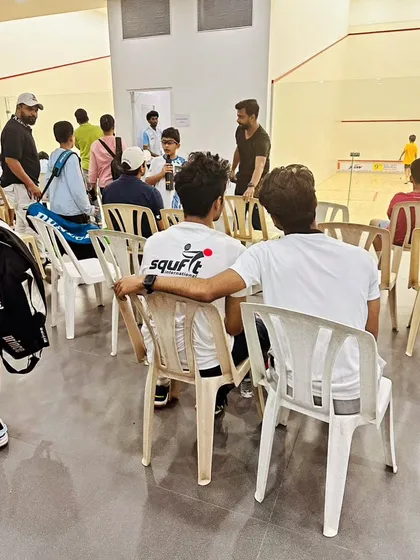 A candid moment of mentorship and team bonding between matches at the JSW Memorial Open.