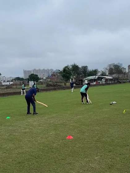 A wide view of a fielding drill in progress. Our group sessions are designed to be dynamic and engaging, with multiple activities running simultaneously to maximize player development across all disciplines.