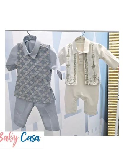 A side-by-side view of two of our popular ethnic outfits for boys. On the left, a grey printed vest set, and on the right, an embroidered white romper-style kurta.