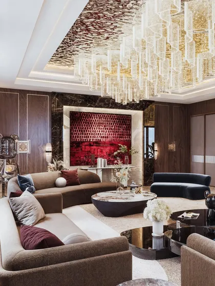 An opulent living area visualization where a massive, multi-tiered glass chandelier dominates the ceiling. The render captures the reflective properties of the glass and the deep, rich tones of the furniture and art.