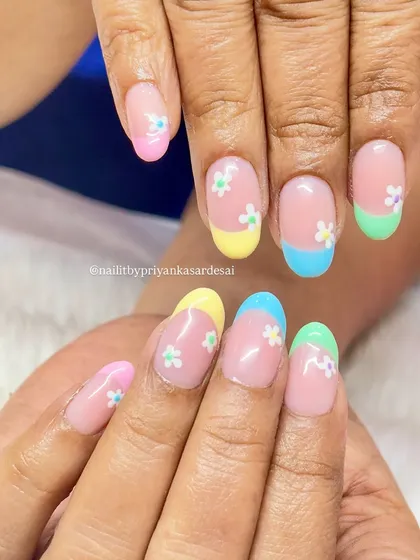 Nails as vibrant as my summer adventures. This fun set features pastel-colored French tips with tiny, delicate daisy accents.