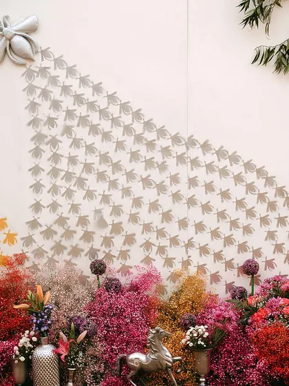 A unique wall installation featuring a swarm of silver bees against a backdrop of colorful flowers. This artistic element was a major conversation starter.