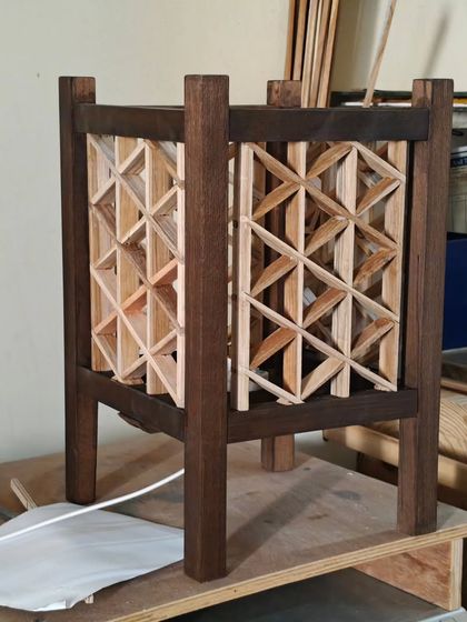 This is a triangle grid Kumiko lamp with a Rindou pattern, shown before the diffuser paper is applied. The dark-stained frame provides a strong contrast to the lighter infill pieces.