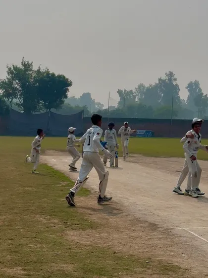 The team gets together to celebrate another fallen wicket.