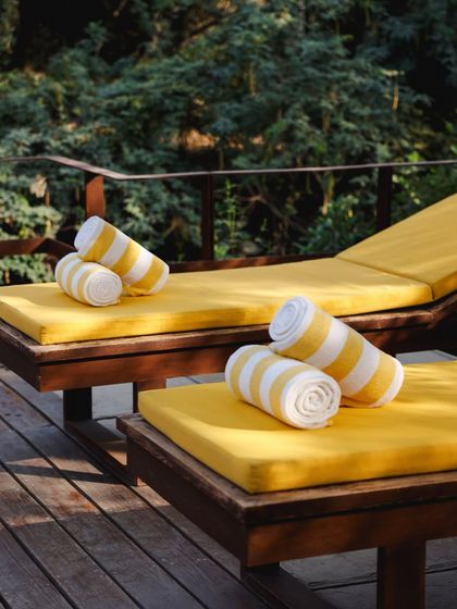 Rolled towels on the sun loungers, a simple detail that speaks to our readiness to provide a comfortable and relaxing experience.