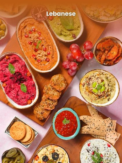 A vibrant Lebanese mezze platter, showcasing a rainbow of colourful and flavourful dips and bites.