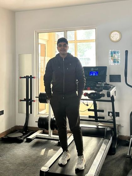 A relaxed pose in a home gym.