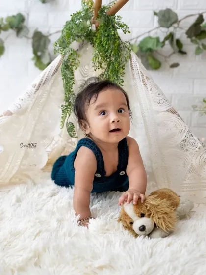 This little explorer is on the move in our simple and sweet boho teepee setup. The clean, white background keeps the focus on his adorable expression.