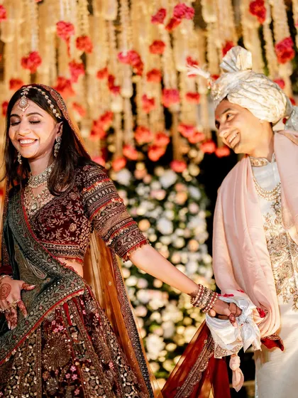 The joy of a Varmala ceremony, perfectly framed. Even though this wedding had to be moved indoors, the happiness of the couple under the floral canopy was radiant.