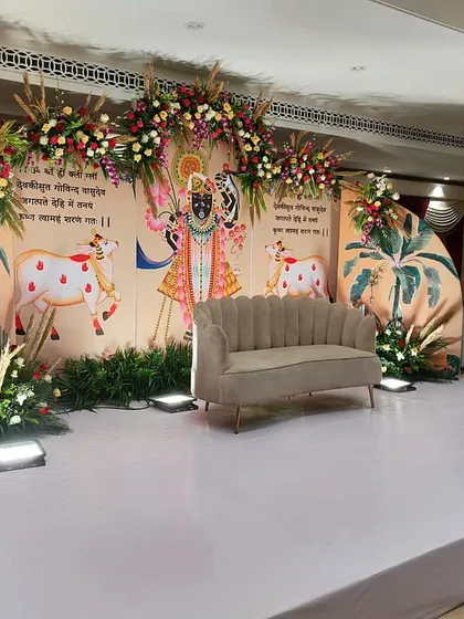 A wider view of the Shrinathji-themed decor, showing the full stage setup. We take great care to ensure our designs for religious events are both beautiful and respectful of cultural traditions.