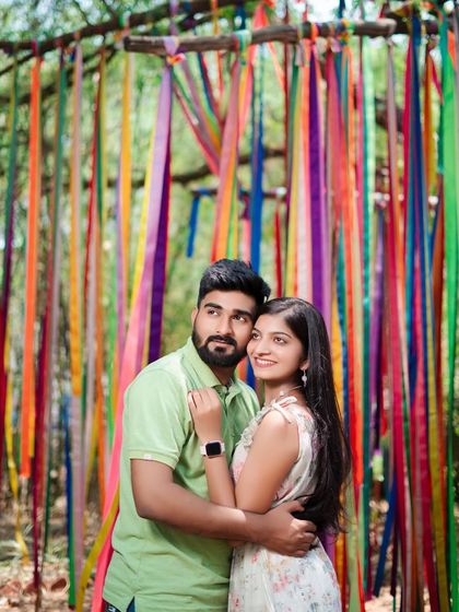 A vibrant and colorful pre-wedding shoot using a backdrop of hanging ribbons. This is a simple but effective way to add a pop of color and fun to your photos.