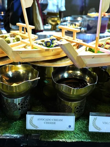 Presentation is just as important as taste. For our Japanese selection, I serve fresh sushi in these unique wooden boats, creating an impressive and memorable display for your event.