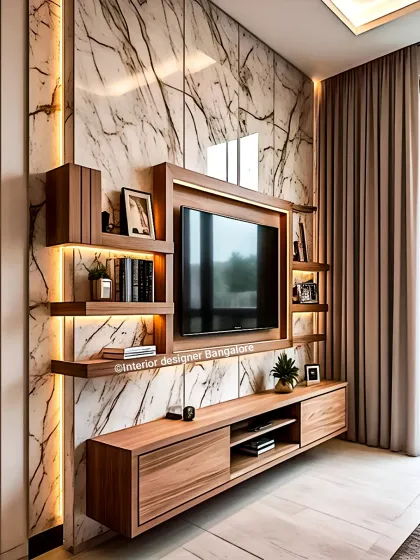 This is an example of my custom entertainment units. I combined a floating console with open shelving and dramatic backlight against a marble-finish wall to create a functional and visually stunning focal point for the living room.