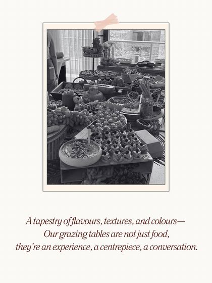 A tapestry of flavors, textures, and colors. This stylized, black and white photo captures the essence of our grazing tables as an experience, a centerpiece that sparks conversation and creates memories.