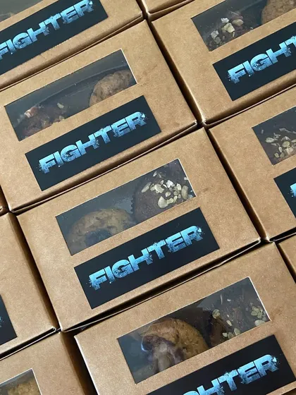 Branded muffin boxes for the 'Fighter' crew, ensuring even the snacks felt special and on-theme.