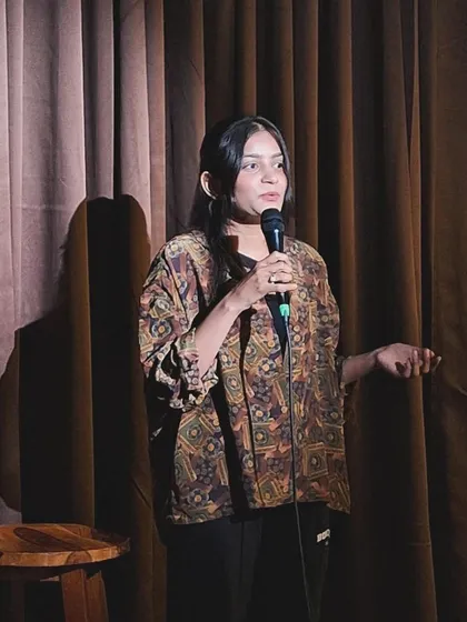 On stage at an open mic, sharing my poetry. This is where my other persona comes to life, balancing the logical world of law with the emotional depth of shayari. It reminds me that a good advocate must also be a compelling storyteller.