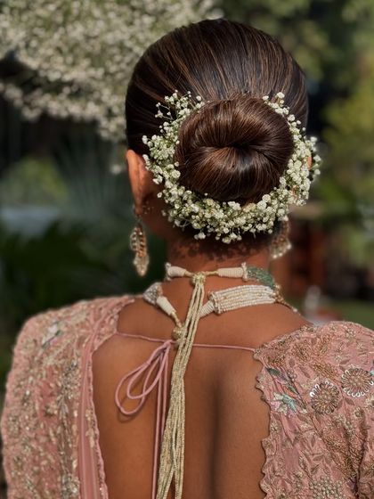 The delicate nature of a baby's breath floral updo, perfect for a romantic bride.