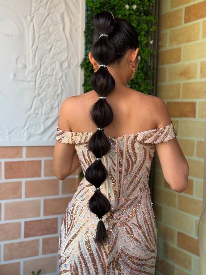 This modern bubble braid, also called a balloon ponytail, is a chic and stylish alternative to a traditional braid. I added small pearl bands to define each section for an elegant finish.