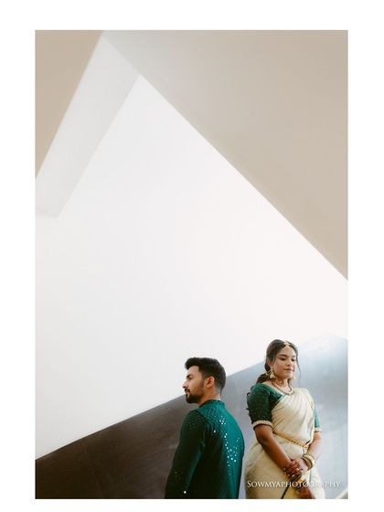 A minimalist and artistic engagement portrait. The geometric background and clean composition make this a very modern and stylish shot.