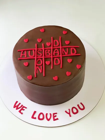 A playful and sweet chocolate cake for a husband, featuring a tic-tac-toe design.