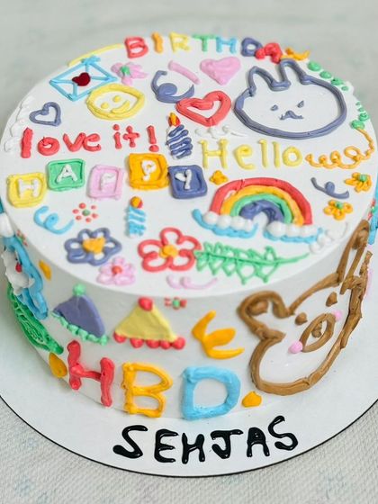 A vibrant and playful doodle-style cake, full of fun characters and colors.