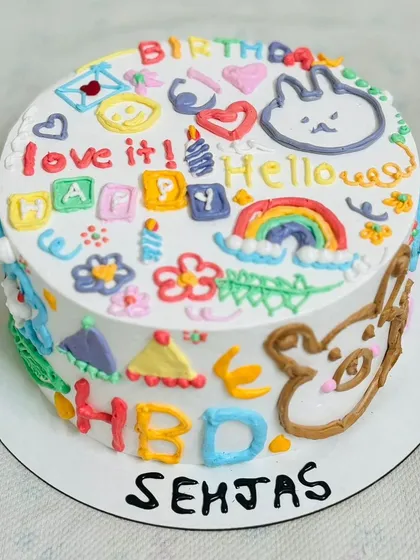 A vibrant and playful doodle-style cake, full of fun characters and colors.