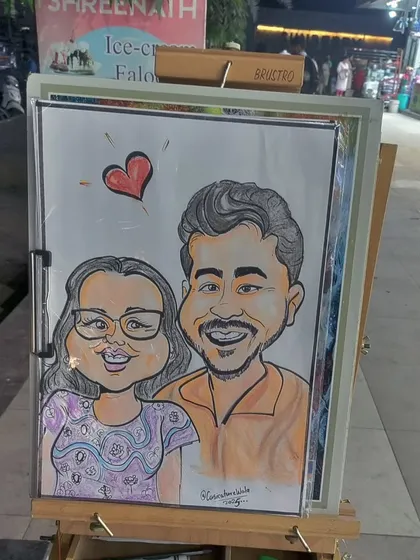 A finished couple's portrait on my easel, ready to be presented. I use quality materials and can add color to create a vibrant, frame-worthy piece of art for your guests.