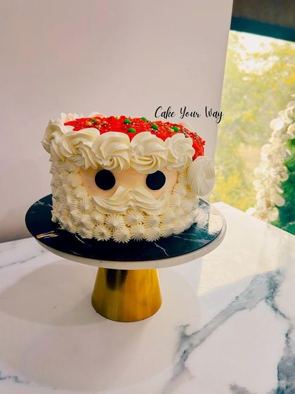 A cute and simple Santa face cake, perfect for a small Christmas gathering.