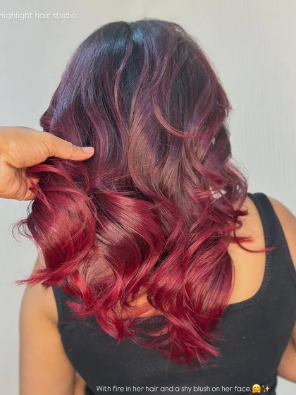 A close up of the texture and color of this fiery red look. The blend from dark roots to bright ends is seamless.