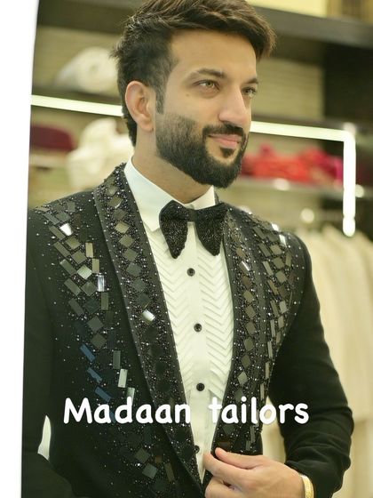 A client looking sharp in our black sequin tuxedo. The geometric pattern on the lapels adds a contemporary edge to this classic party-ready outfit.