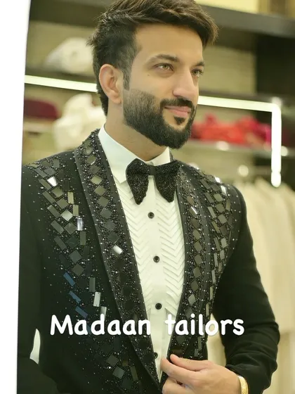 A client looking sharp in our black sequin tuxedo. The geometric pattern on the lapels adds a contemporary edge to this classic party-ready outfit.