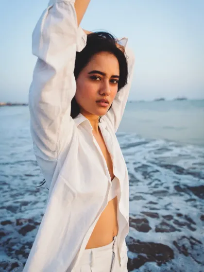 A confident and relaxed beach portrait. The open shirt and direct gaze create an image that is both alluring and strong.