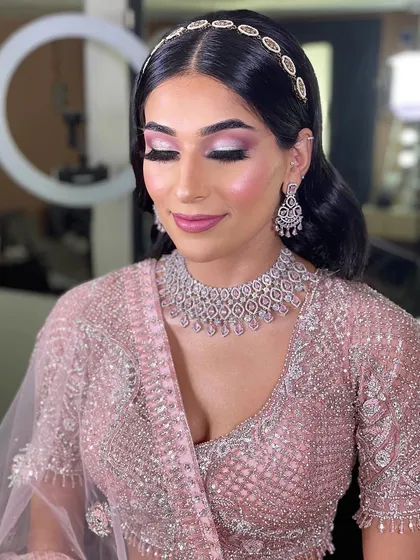 This client is glowing for her engagement ceremony. The look features luminous skin, soft pink eyeshadow, and a delicate diamond choker, creating a look of pure elegance.