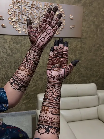 Another angle of the baby shower mehendi, showing the cute little elements like tiny feet and cradles woven into the design.