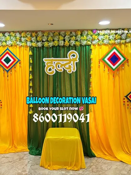 We create beautiful Haldi decorations for intimate home ceremonies. This setup uses a clean arrangement of drapes and signs to create a perfect photo spot.