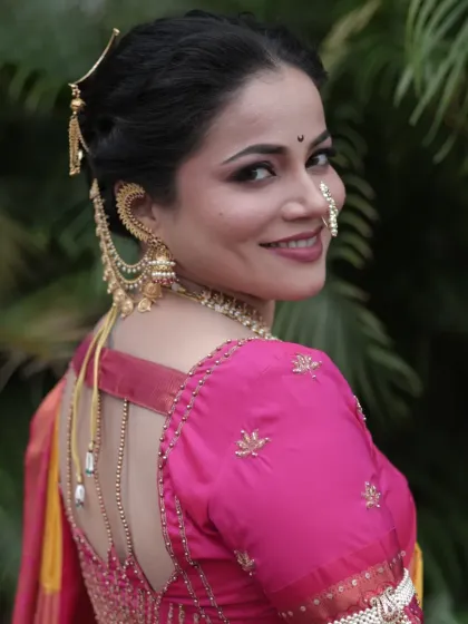 A lovely over-the-shoulder shot showing the back of the blouse and the detailed hairstyle.